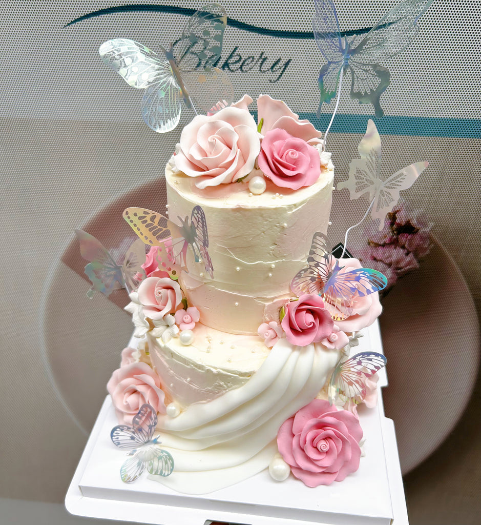 Fondant pink flowers and butterflies cake