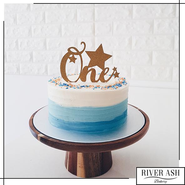 Denim Blue Cake with white flowers | Order Cakes Online by Kukkr